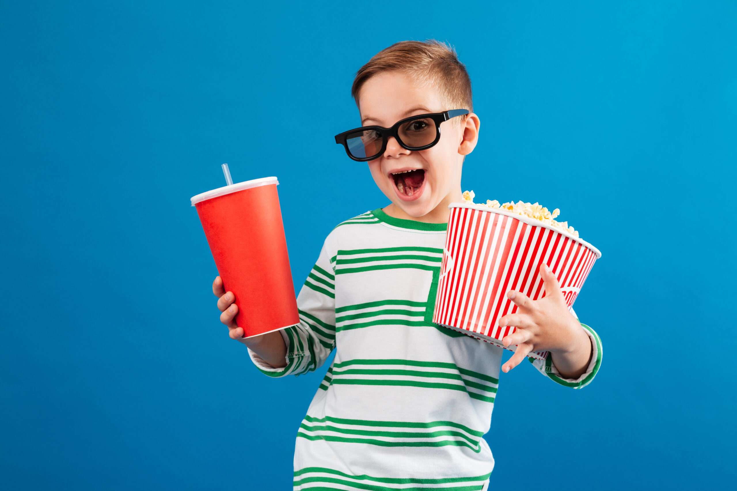 cheerful young boy in eyeglasses preparing to watch the film scaled