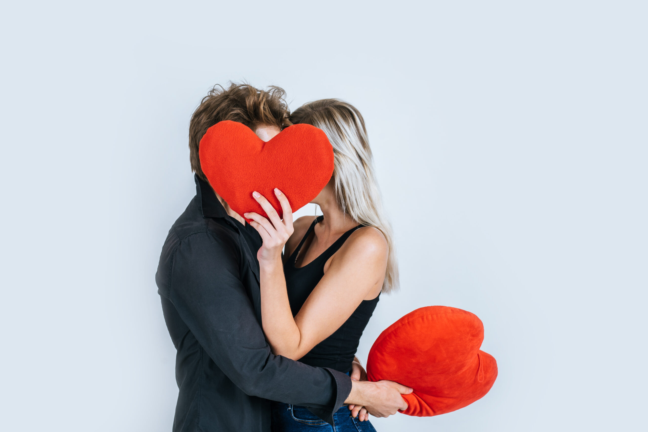 happy couple loving together holding a red heart scaled